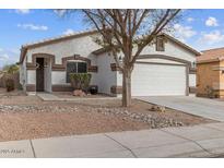 Charming single-story home features a two-car garage and low maintenance desert landscaping at 330 E Cheyenne Rd, San Tan Valley, AZ 85143