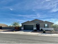 Charming single-story home with a well-manicured front yard and a two-car garage at 4459 E Warlander Ln, San Tan Valley, AZ 85140