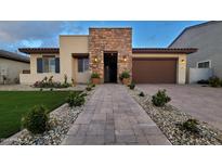 Inviting single Gathering home with manicured lawn, stone accents, and a two-car garage at 6225 S Boulder St, Gilbert, AZ 85298