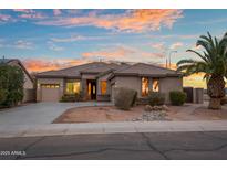 Beautiful single-story home featuring desert landscaping, a two-car garage, and a tile roof at sunset at 6993 S Roger Way, Chandler, AZ 85249