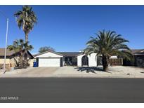 Charming single-story home with desert landscaping and a two-car garage at 7350 E Pueblo Ave, Mesa, AZ 85208