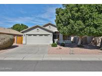 Charming single-story home with a two-car garage and desert landscaping at 7642 W Carlota Ln, Peoria, AZ 85383