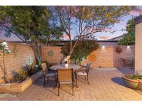 Charming brick patio with a round table and chairs, perfect for outdoor dining and relaxation at 7912 E Plaza Ave, Scottsdale, AZ 85250