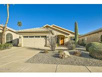 Charming single-story home featuring desert landscaping, an attached garage, and a welcoming front entrance at 8632 E Gail Rd, Scottsdale, AZ 85260