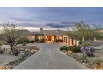 Stunning home features a desert landscape, brick driveway, and grand entrance at 10238 E Rising Sun Dr, Scottsdale, AZ 85262