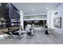 Open-concept living room with high ceilings and a wall of windows to the exterior at 11578 N 80Th Pl, Scottsdale, AZ 85260