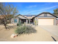 Charming single-story home with desert landscaping, solar panels, and neutral color palette at 15056 N 43Rd St, Phoenix, AZ 85032