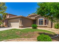 Charming single-story home with well-maintained landscaping and a welcoming front entrance at 16188 W Hearn Rd, Surprise, AZ 85379