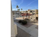 Community pool with a pergola and seating available to residents at 16635 N Cave Creek Rd # 213, Phoenix, AZ 85032