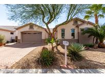 Charming single-story home featuring well-maintained landscaping and a two-car garage at 18261 W Weatherby Dr, Surprise, AZ 85374