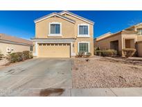 Inviting two-story home featuring a two-car garage and low-maintenance desert landscaping at 21876 W Mohave St, Buckeye, AZ 85326