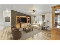Inviting living room with comfortable seating, a large entertainment center, and modern decor at 2263 N Trekell Rd # 175, Casa Grande, AZ 85122