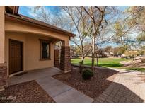 Inviting front porch with stone accents and meticulous landscaping at 2454 E Vermont Dr, Gilbert, AZ 85295