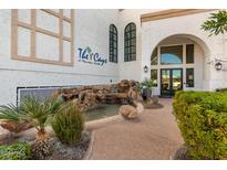 Inviting entrance to The Cays features a charming water feature and lush landscaping at 2511 W Queen Creek Rd # 323, Chandler, AZ 85248