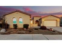 Charming home featuring stucco siding, a tile roof, and desert landscaping during a beautiful sunset at 26199 S 227Th St, Queen Creek, AZ 85142