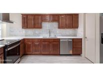 This kitchen features custom cabinets, stainless steel appliances, and granite countertops at 2907 S Elm St, Tempe, AZ 85282