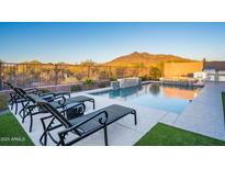 Backyard pool features a built in waterfall, BBQ, mountain views, and lounge seating at 34801 N 53Rd St # 29, Cave Creek, AZ 85331