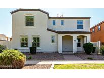 Inviting two-story home with a stucco facade, covered entryway, and well-maintained landscaping at 3555 E Erie St, Gilbert, AZ 85295