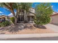 Charming home exterior featuring desert landscaping, mature trees, and inviting entrance at 7304 E Northridge Cir, Mesa, AZ 85207