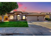 Beautiful single-story home featuring a tile roof, arched entryway, and a well-manicured front lawn at 741 W Harvard Ave, Gilbert, AZ 85233