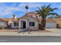 Charming two-story home with tile roof, stucco exterior, and landscaped front yard featuring a mature palm tree at 811 N Los Feliz Dr, Chandler, AZ 85226