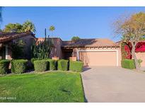 Charming single-story home with desert landscaping, tile roof, and attached two-car garage at 8138 E Via De La Escuela --, Scottsdale, AZ 85258