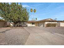 Charming single-story home with desert landscaping, long driveway and a two car garage at 829 S Revolta Cir, Mesa, AZ 85208