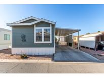 Charming manufactured home featuring a covered carport and manicured landscaping at 8865 E Baseline Rd # 1731, Mesa, AZ 85209
