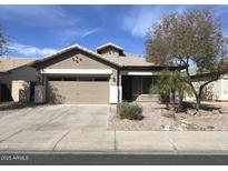 Charming single story home with desert landscaping, two car garage, and covered porch at 11946 W Jackson St, Avondale, AZ 85323