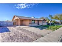 Charming single story home with neutral paint, covered carport, and low maintenance gravel yard at 1340 N Oregon St, Chandler, AZ 85225