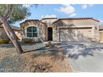 Charming single-story home with a two-car garage, neutral stucco, and terracotta roof tiles at 13624 W Desert Moon Way, Peoria, AZ 85383