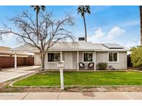 Charming home featuring a well-maintained lawn and covered carport at 14008 N 61St Ave, Glendale, AZ 85306