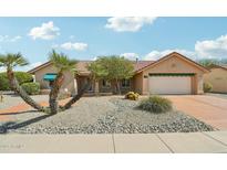 Single-story home featuring desert landscaping, attached garage, and a neutral color palette at 14432 W Yukon Dr, Sun City West, AZ 85375