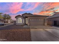 Charming single-story home featuring a two-car garage, low maintenance desert landscaping, and a tile roof at 151 N 116Th Dr, Avondale, AZ 85323