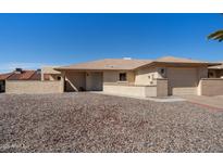 Charming single-story home with a well-maintained yard and inviting curb appeal under a clear blue sky at 1612 Leisure World --, Mesa, AZ 85206