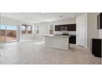 Open-concept living room and kitchen area with tile flooring and natural light at 1768 W Storia Ave, Apache Junction, AZ 85120