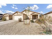 Charming single-story home featuring low-maintenance desert landscaping and an attached two-car garage at 1992 E Shetland Dr, San Tan Valley, AZ 85140