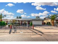 Charming single-story home with stone accents, a well-manicured front yard, and a covered carport at 238 N 62Nd St, Mesa, AZ 85205