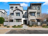 Beautiful modern townhome exterior featuring a gated entrance, desert landscaping, and stylish design at 300 N Gila Springs Blvd # 141, Chandler, AZ 85226