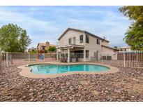 Inviting backyard pool with rock landscaping, and a charming two-story home featuring a second-story balcony at 3034 N Ricardo --, Mesa, AZ 85215