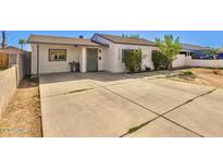 Inviting single-story home featuring a spacious driveway and freshly painted exterior at 3129 W Pierce St, Phoenix, AZ 85009