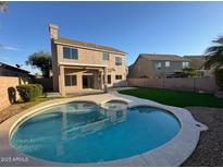 Backyard featuring a refreshing pool, spa, and covered patio, creating an ideal outdoor living space at 4216 E Tether Trl, Phoenix, AZ 85050