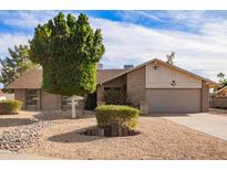 Charming single-story home featuring desert landscaping and a brick exterior at 4409 E Gelding Dr, Phoenix, AZ 85032