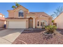 Charming two-story home featuring a tile roof, two car garage and low maintenance desert landscaping at 819 W Kyle E Ct, Gilbert, AZ 85233