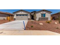 Inviting single-Gathering home features desert landscaping, neutral stucco and a two car garage at 8553 N 175Th Ln, Waddell, AZ 85355