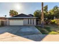 Charming single-story home with brick accents, a two-car garage and mature landscaping at 8626 N 50Th Ln, Glendale, AZ 85302