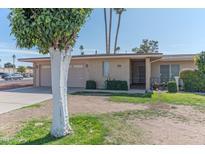 Charming single-story brick home with two-car garage and well-maintained front yard at 10701 W Mountain View Rd, Sun City, AZ 85351