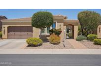 Charming single-story home featuring desert landscaping, gated front entry and attached two-car garage at 12956 W Eagle Ridge Ln, Peoria, AZ 85383