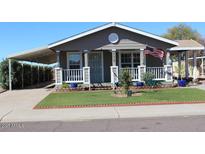 Charming single-story home with well-manicured front yard and covered parking at 17016 N 66Th Ter, Glendale, AZ 85308