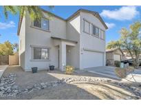 Two-story home featuring neutral-toned stucco, a two-car garage, and low-maintenance gravel landscaping at 2013 E Dust Devil Dr, San Tan Valley, AZ 85143